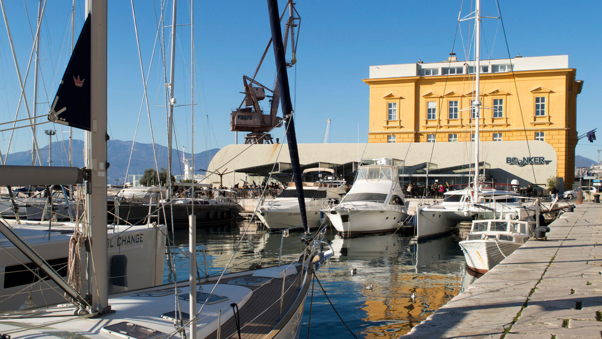 Boonker restaurant in Rijeka with waterfront setting, yachts, and historic concrete structure.